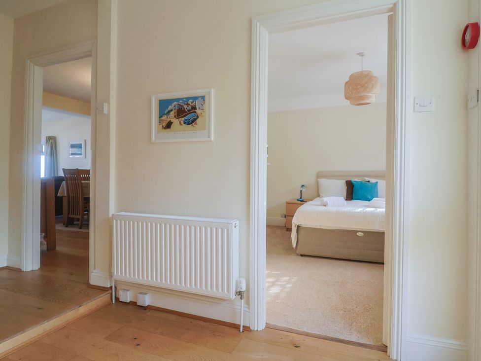 A hallway with doorways leading to a bedroom and dining area at Greystones in Lyme Regis