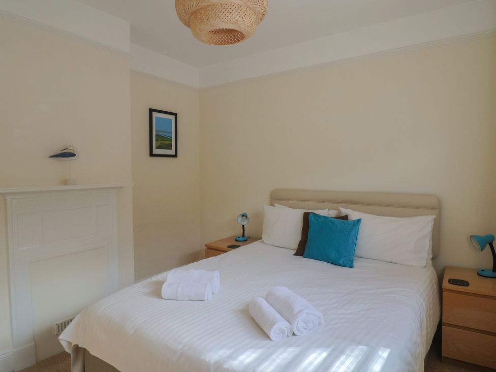 A bedroom with a bed and bedside tables at Greystones in Lyme Regis