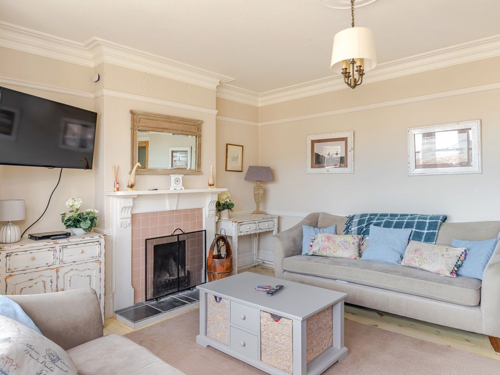 A living room with a television and fireplace at 2 Hadleigh Villas Lyme Regis