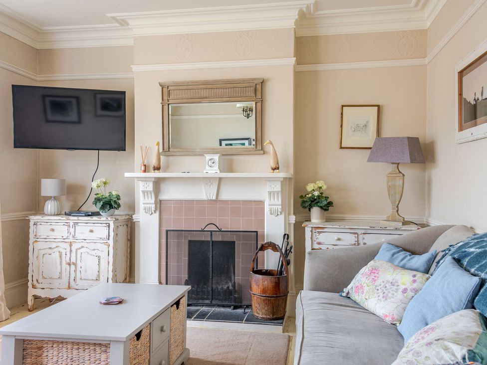 A living room with a fireplace and television at 2 Hadleigh Villas Lyme Regis