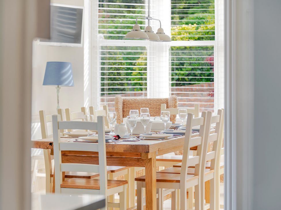 A dining room featuring a table set with tableware at 2 Hadleigh Villas Lyme Regis