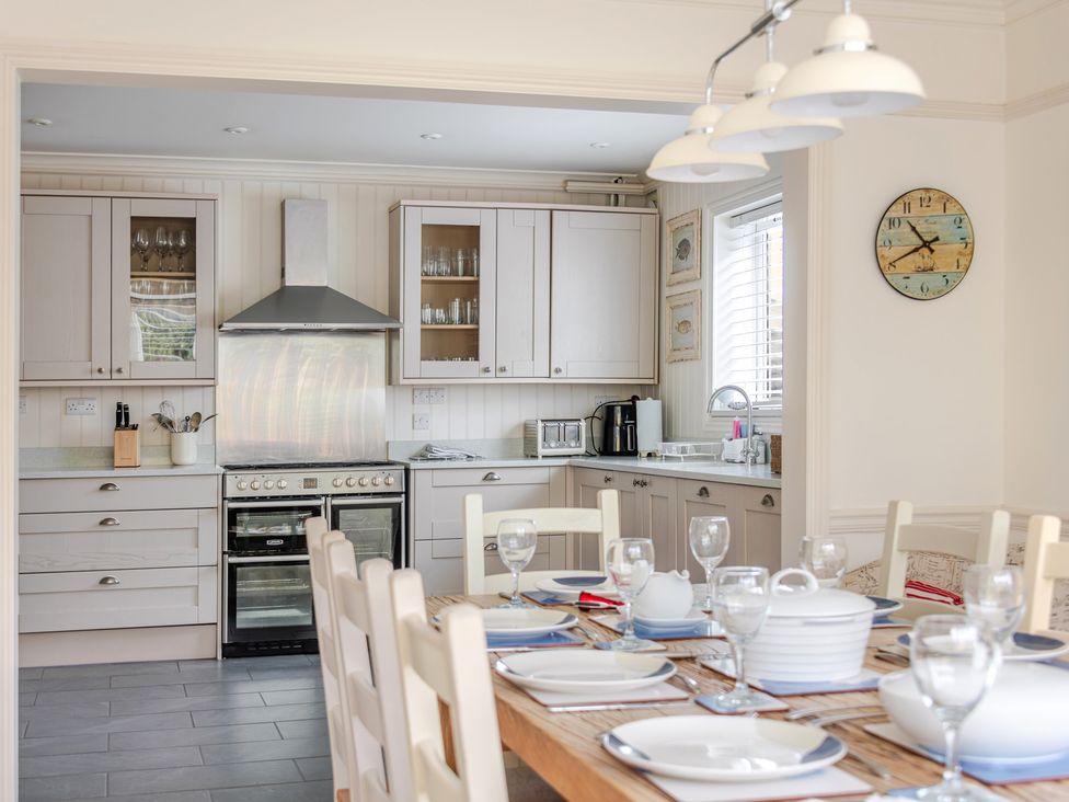 A kitchen with a dining table set for meals at 2 Hadleigh Villas in Lyme Regis