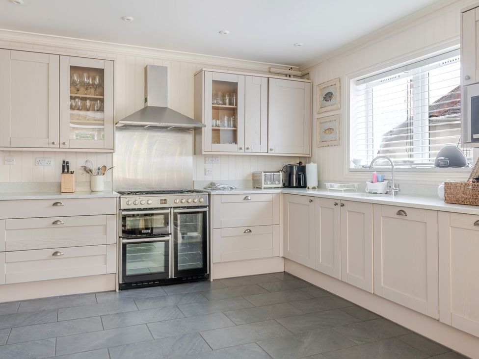 A kitchen with cabinets and appliances at 2 Hadleigh Villas in Lyme Regis