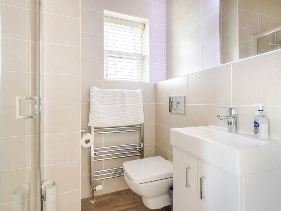 A bathroom with a shower, toilet, and sink at 2 Hadleigh Villas in Lyme Regis