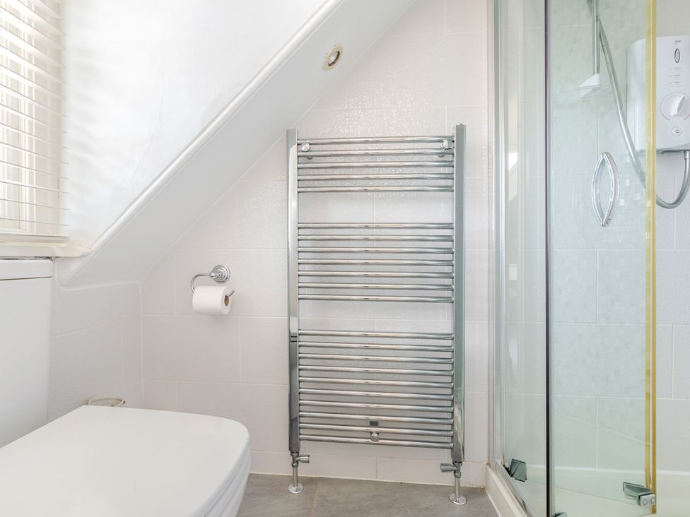 A bathroom with a towel rail and a shower at 2 Hadleigh Villas Lyme Regis