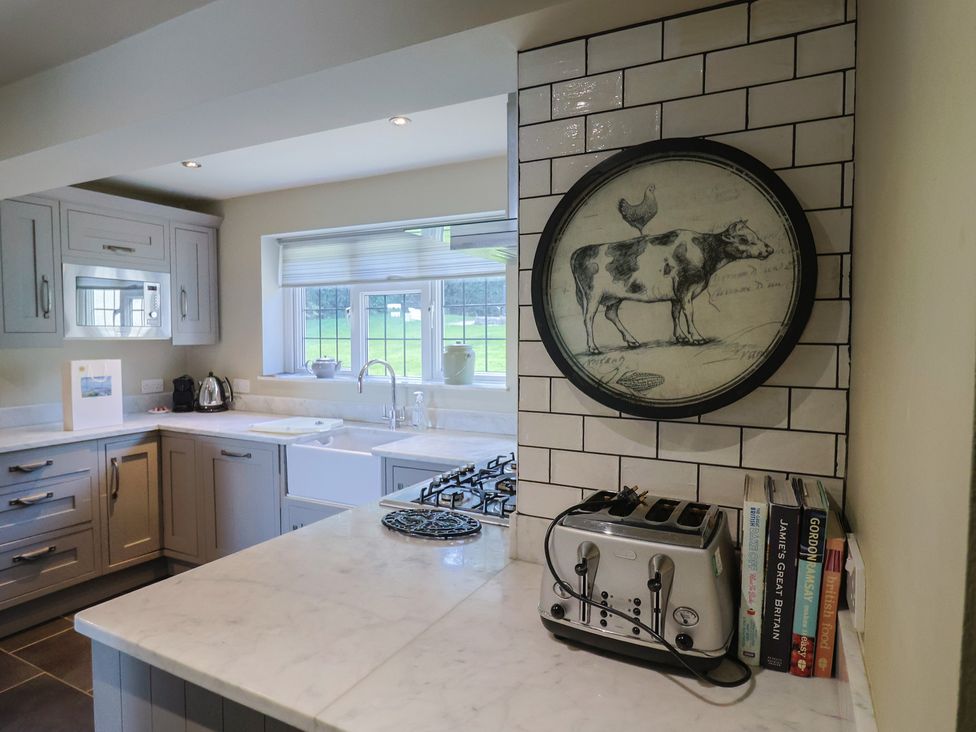 A kitchen with a gas stove and sink at Westhaven in Lyme Regis