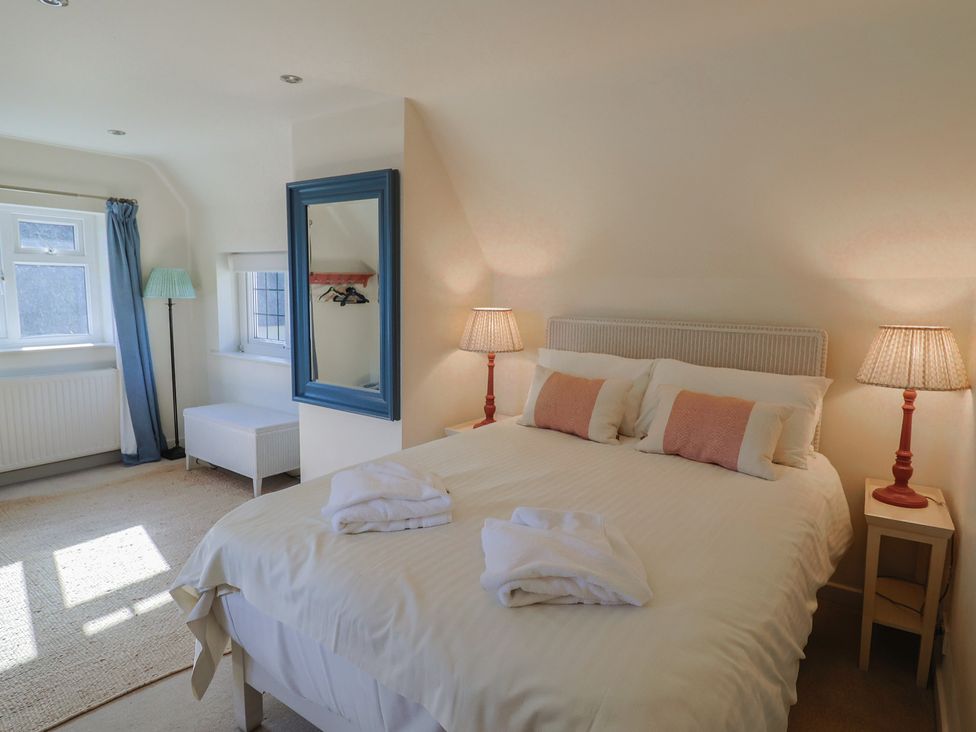 A bedroom with a bed and lamps at Westhaven in Lyme Regis