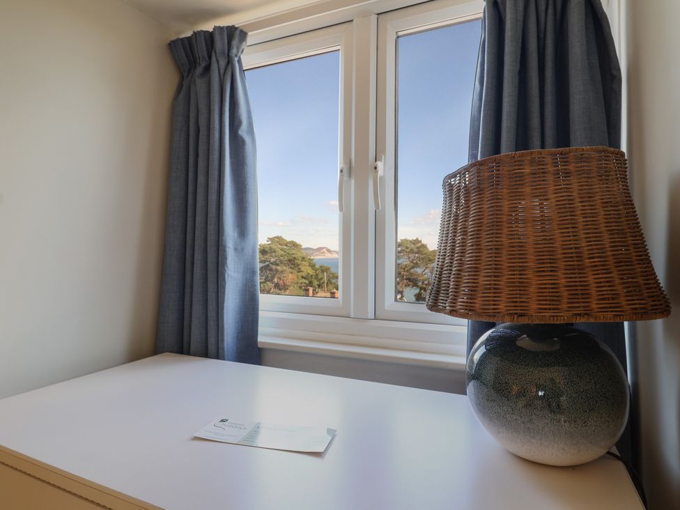 A bedroom with a window and lamp at Westhaven in Lyme Regis