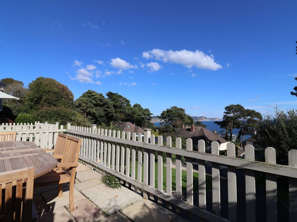 An outdoor space with a table and chairs at Westhaven in Lyme Regis