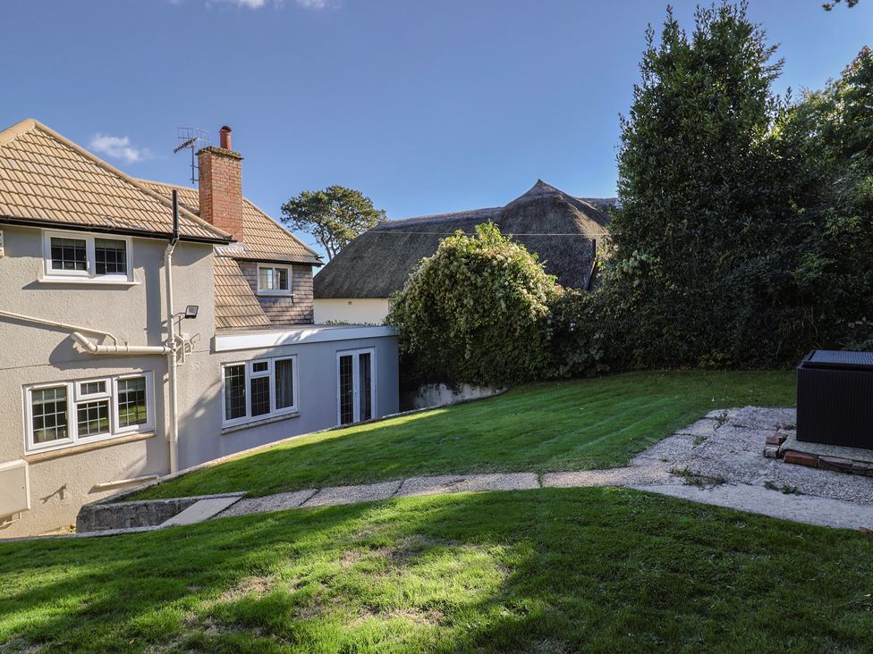 A garden with grass and trees at Westhaven in Lyme Regis