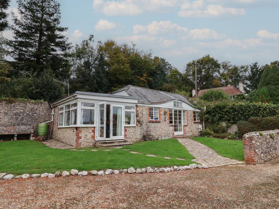 A bungalow with garden and pathway at Penny Plot Cottage in Lyme Regis