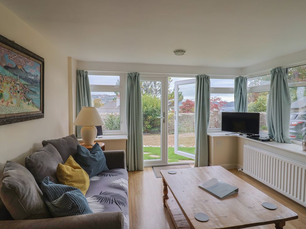 A living room with a sofa and coffee table at Penny Plot Cottage in Lyme Regis