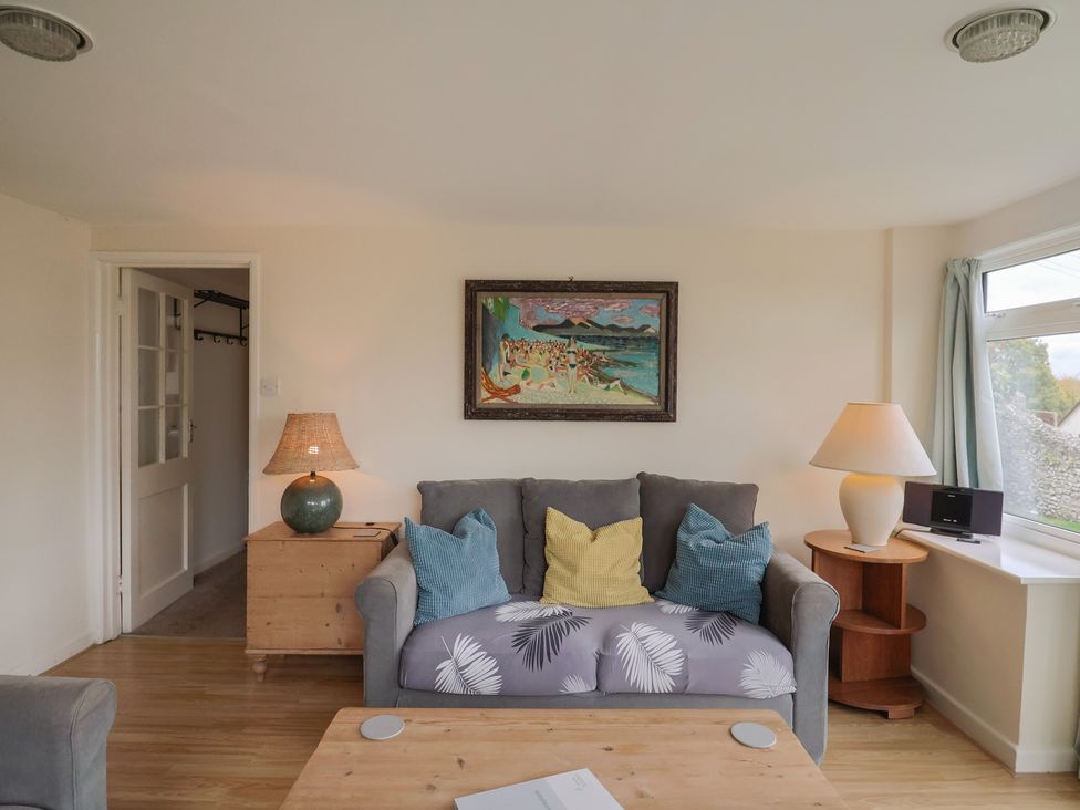 A living room with a sofa and coffee table at Penny Plot Cottage in Lyme Regis