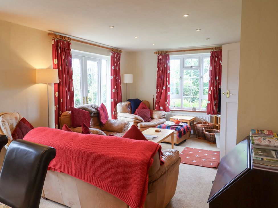 A living room with a sofa and coffee table at Barn Close Farm Morcombelake