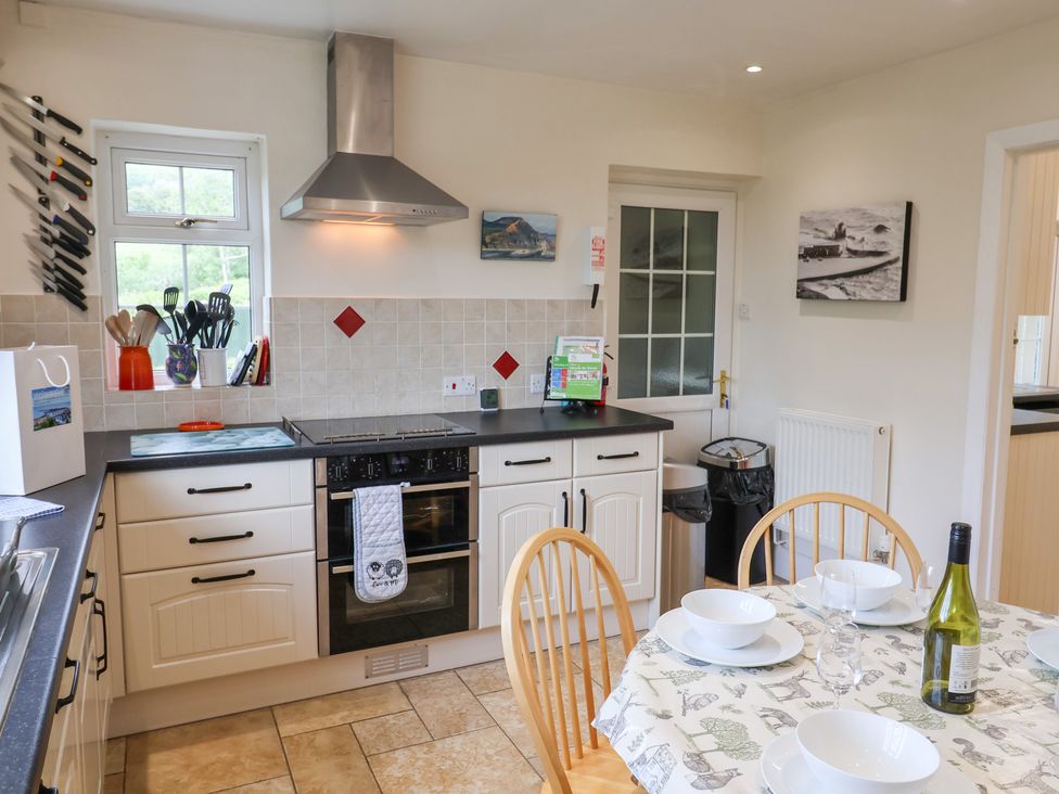A kitchen with utensils and a dining table at Barn Close Farm in Morcombelake