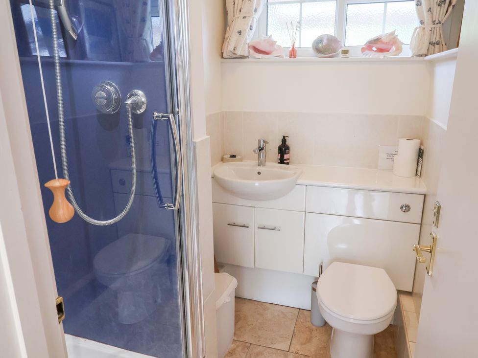 A bathroom with shower, toilet, and sink at Barn Close Farm in Morcombelake