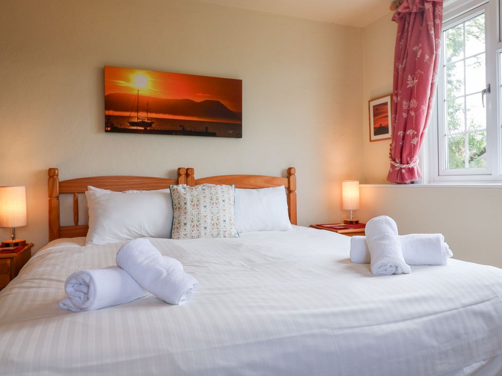 A bedroom with a bed and a window at Barn Close Farm in Morcombelake