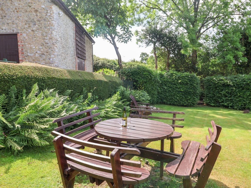 A garden with a table and chairs at Barn Close Farm Morcombelake