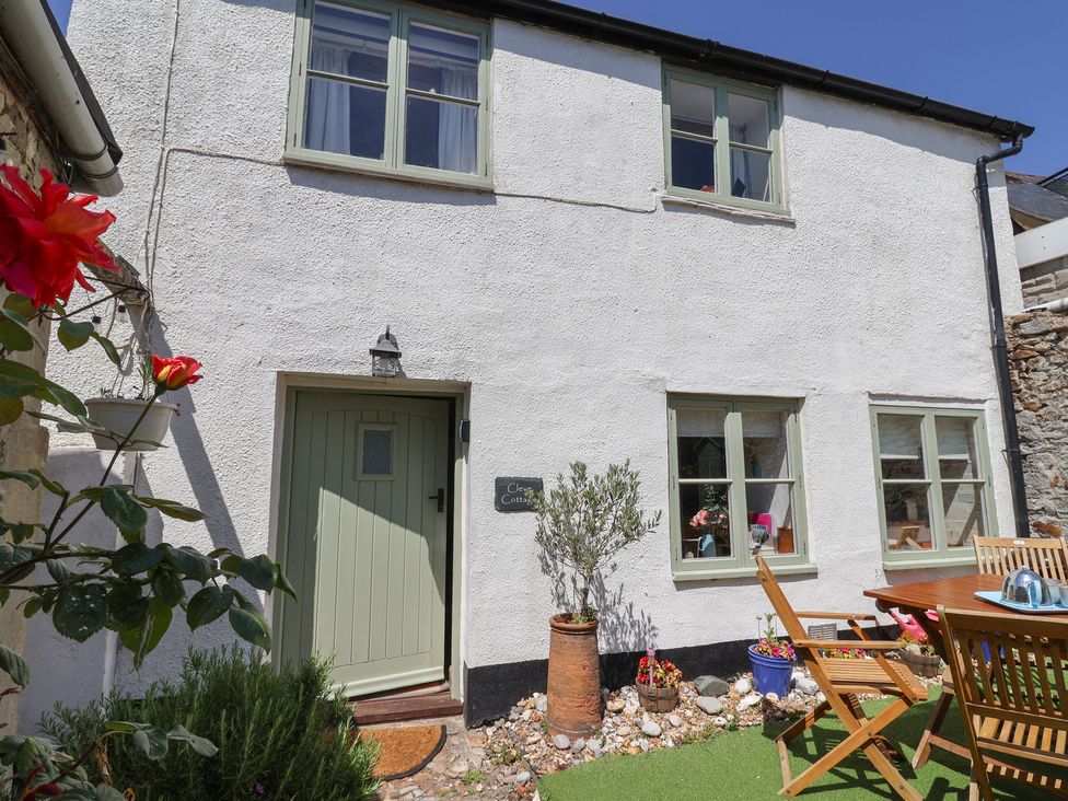 An exterior view of Cleve Cottage with door and garden in Lyme Regis