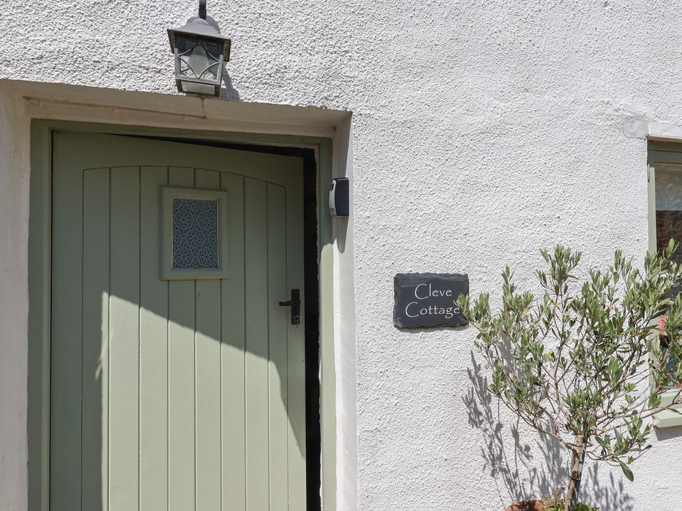 An entrance with a door and nameplate at Cleve Cottage in Lyme Regis