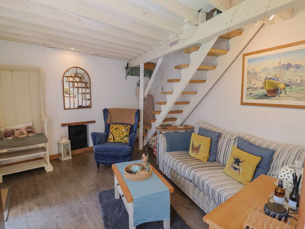 A living room with a sofa and chair at Cleve Cottage in Lyme Regis