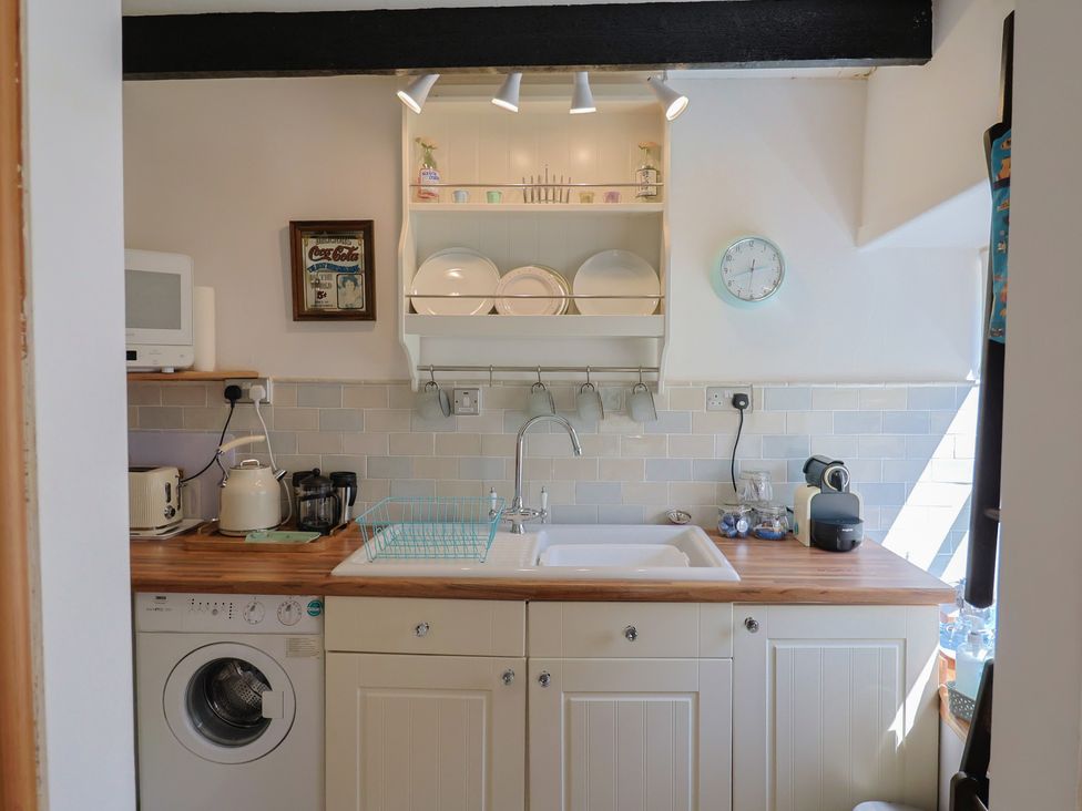 A kitchen with a sink and appliances at Cleve Cottage in Lyme Regis