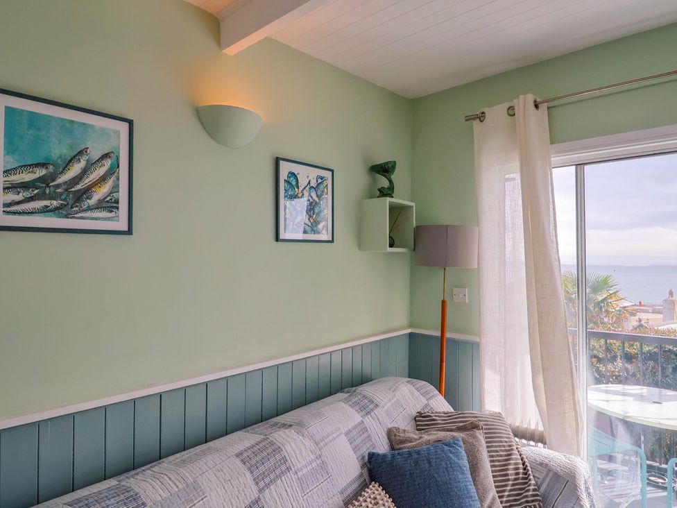 A living room with a sofa and window at 1 Wellhayes Lyme Regis