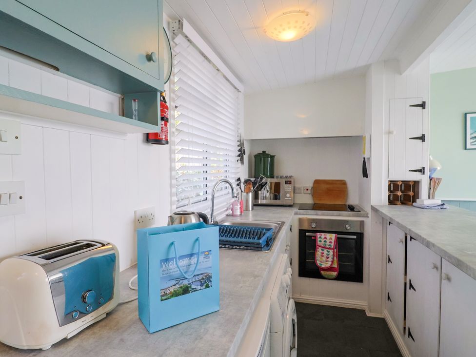A kitchen with a sink and appliances at 1 Wellhayes Lyme Regis