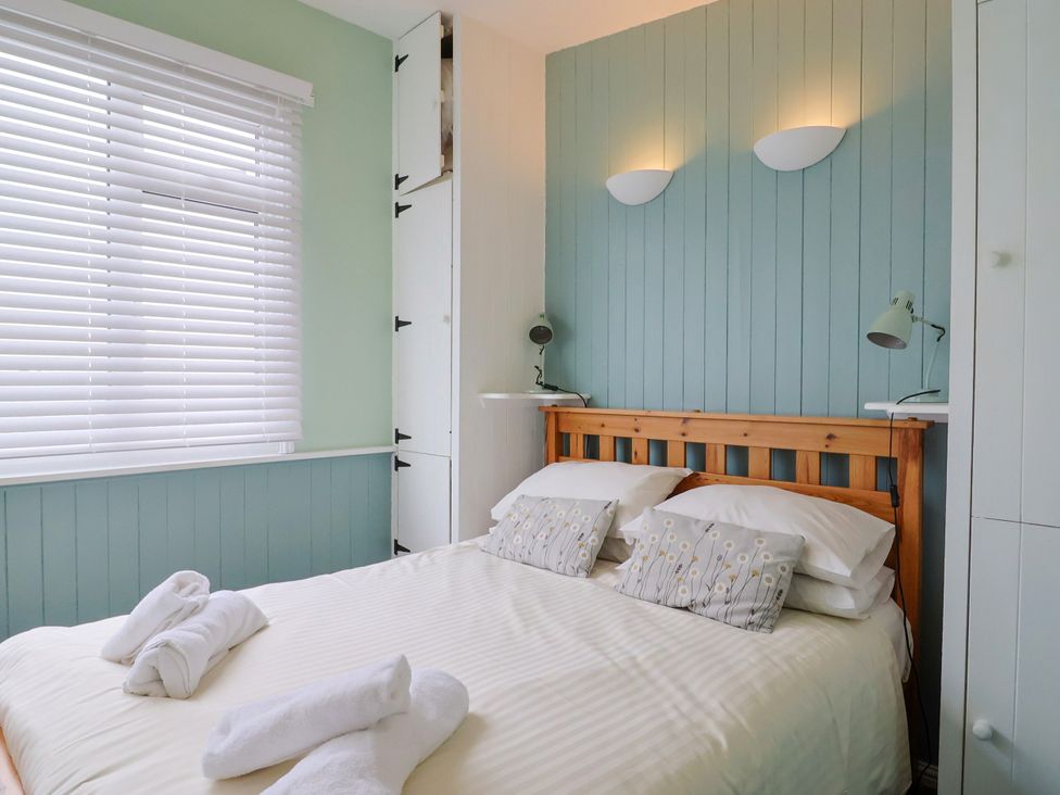 A bedroom with a bed and pillows at 1 Wellhayes, Lyme Regis
