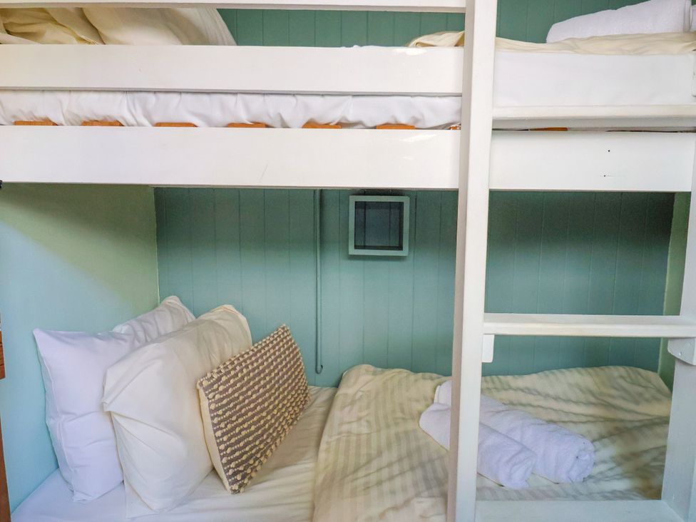 A bunk bed with pillows and a towel at 1 Wellhayes in Lyme Regis