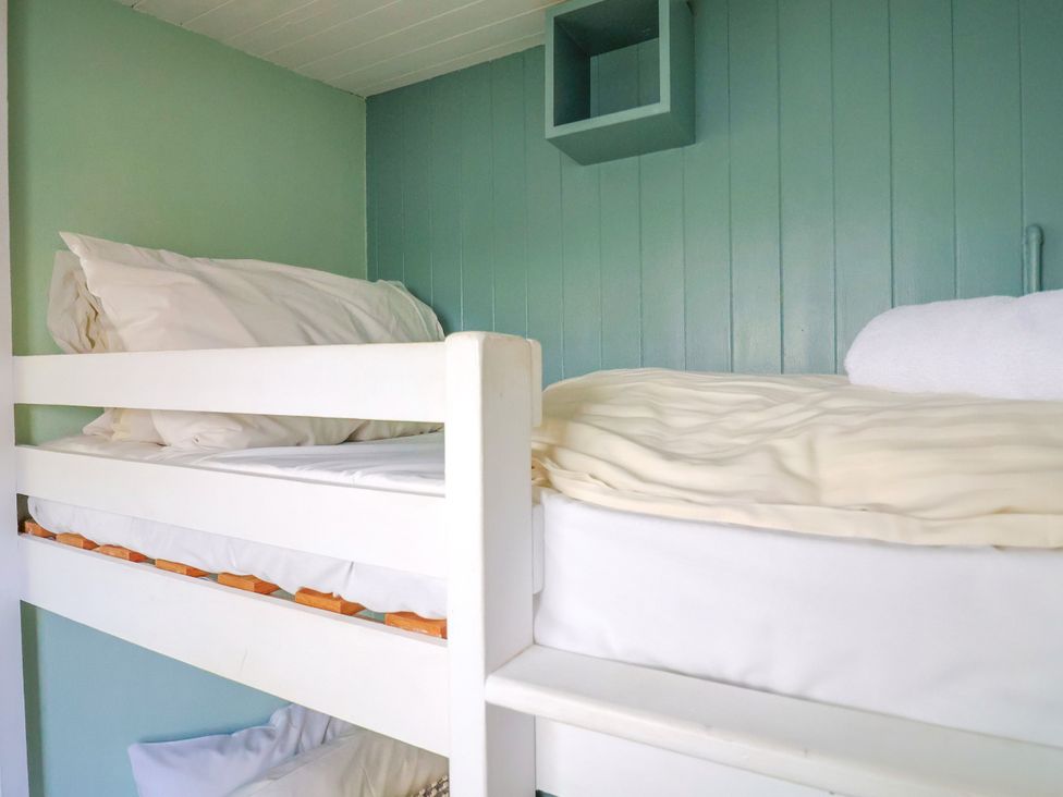 A bedroom with a bunk bed and shelf at 1 Wellhayes, Lyme Regis