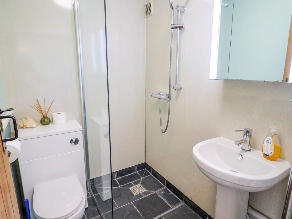 A bathroom with a shower, toilet, and sink at 1 Wellhayes in Lyme Regis
