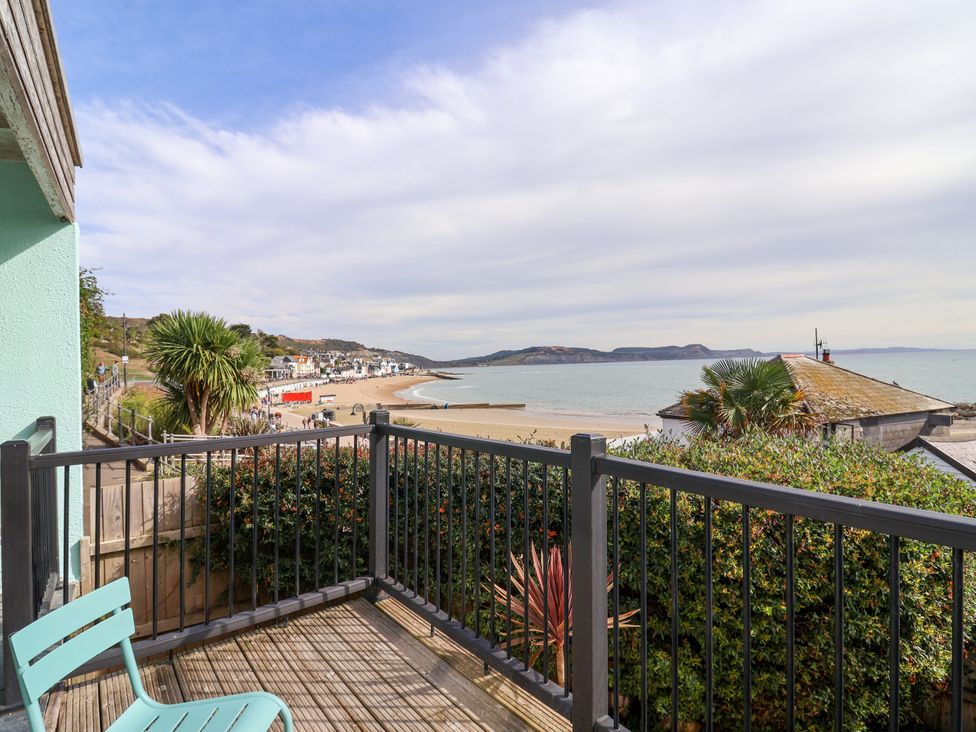 A balcony view of the sea and beach at 1 Wellhayes in Lyme Regis