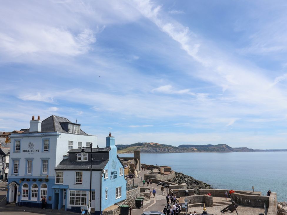 A coastal view with a blue building at 1 Wellhayes in Lyme Regis