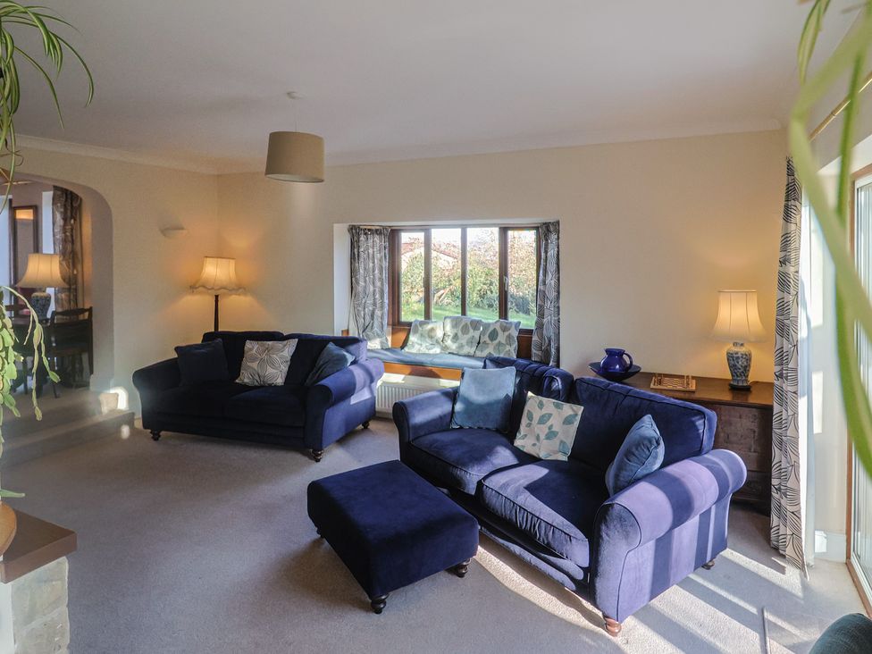 A living room with sofas and a coffee table at High Cliff Orchard in Lyme Regis