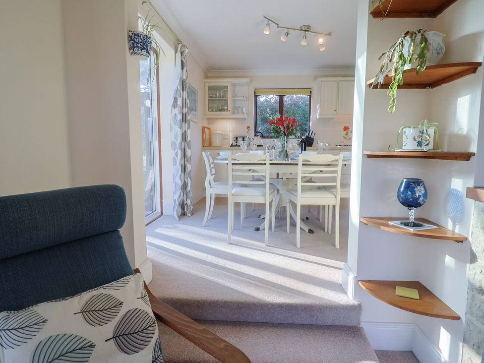 A dining room with a table and chairs at High Cliff Orchard in Lyme Regis