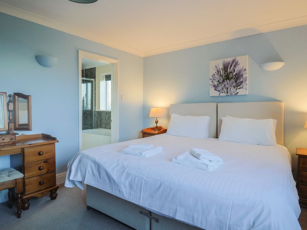 A bedroom with a bed and a dresser at High Cliff Orchard in Lyme Regis