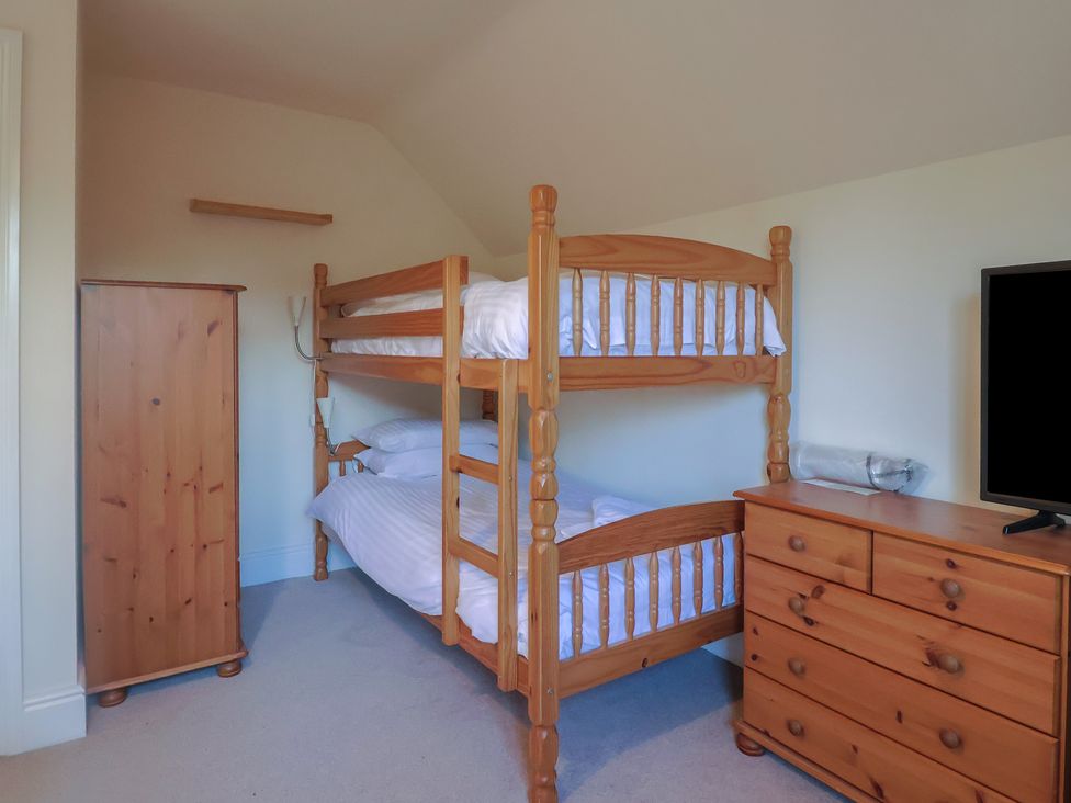 A bedroom with bunk bed and dresser at High Cliff Orchard Lyme Regis