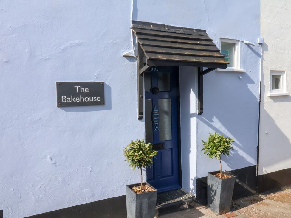 An entrance with a blue door and sign at The Bakehouse in Lyme Regis