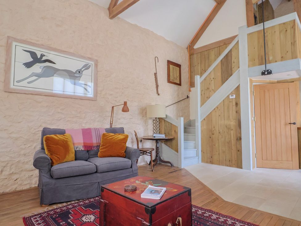 A living room with a sofa and coffee table at The Stone Barn in Bridport