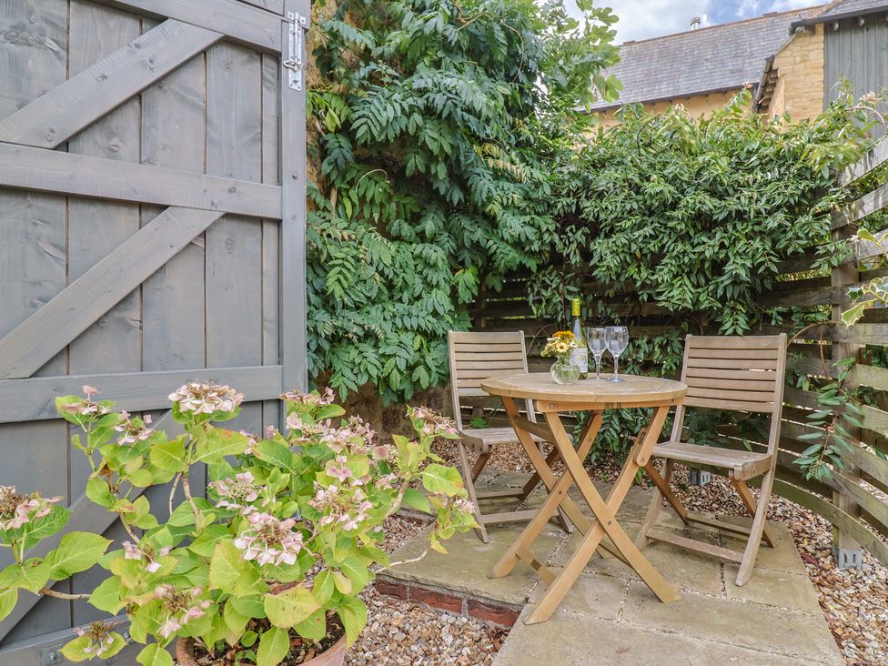 A garden with a table and chairs at The Stone Barn in Bridport