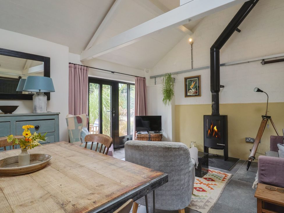 A living room with a table and chairs at The Dairy in Bridport