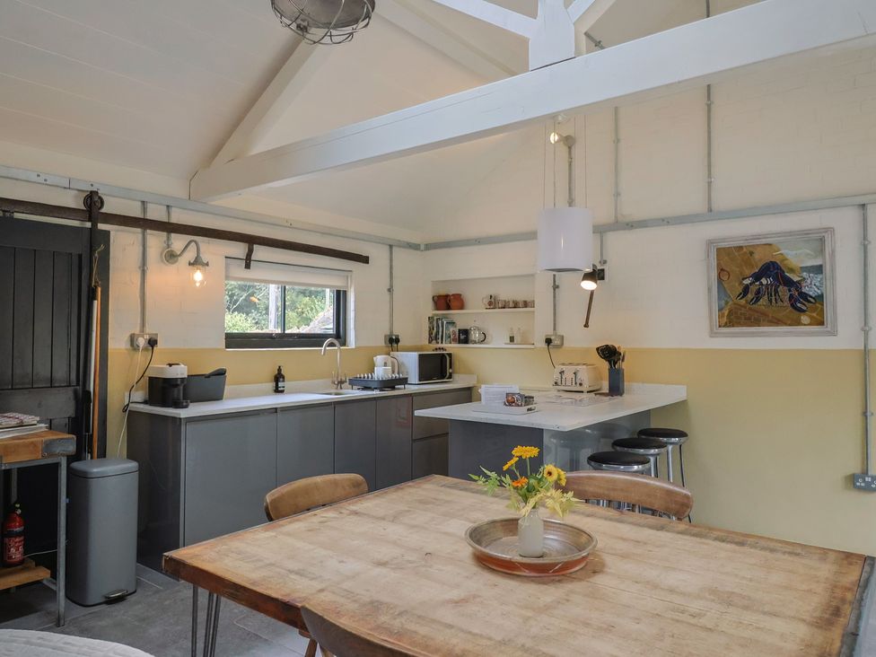 A kitchen with a table and chairs at The Dairy in Bridport