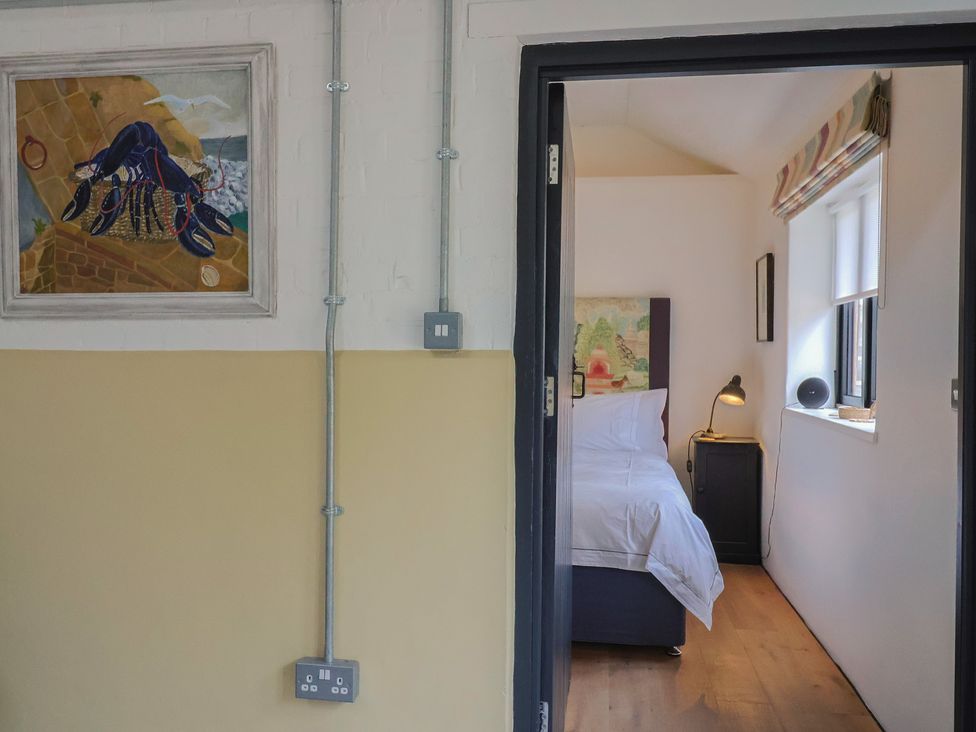 A bedroom with a bed and lamps at The Dairy in Bridport