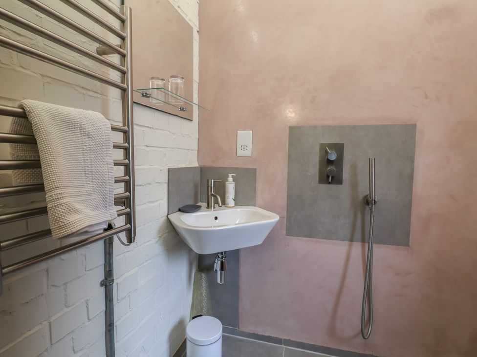 A bathroom with a sink and shower at The Dairy in Bridport
