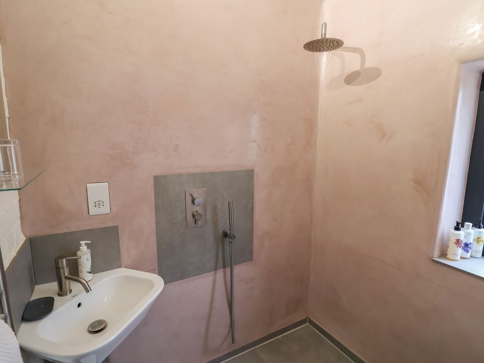 A bathroom with a shower and sink at The Dairy, Bridport