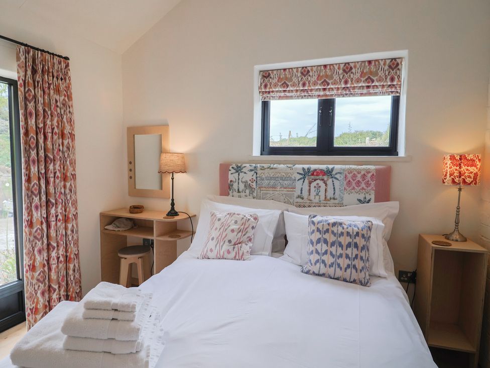 A bedroom with a bed and lamps at The Dairy in Bridport