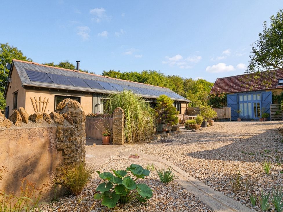 An outdoor area with a building and gravel at The Dairy in Bridport