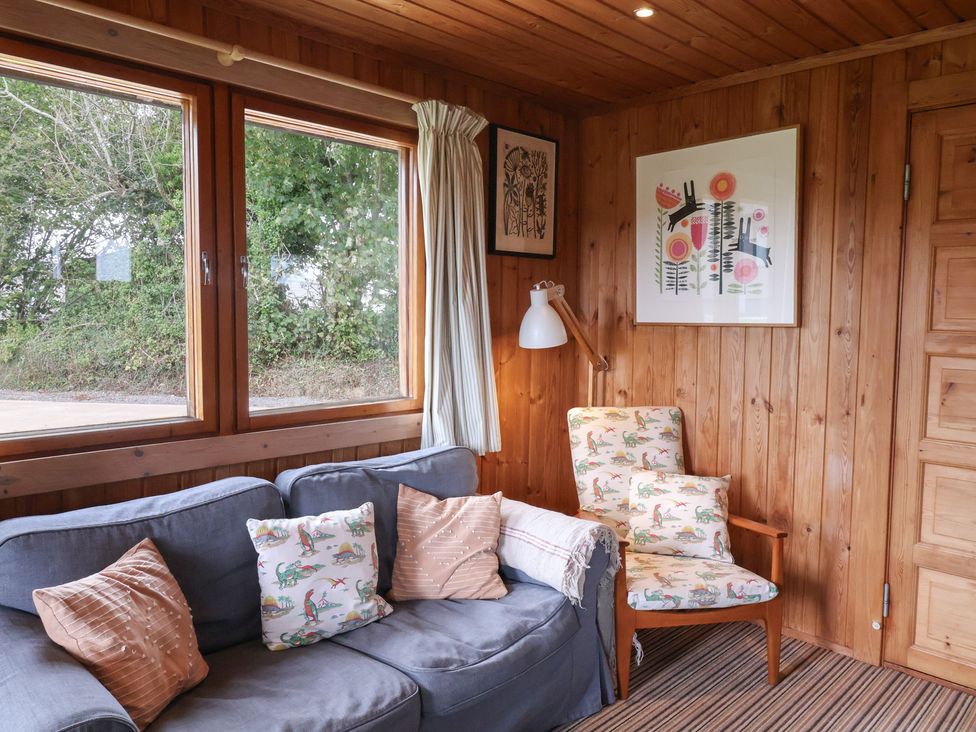 A snug with a sofa and armchair at 10 Pinewood Retreat in Pinewood