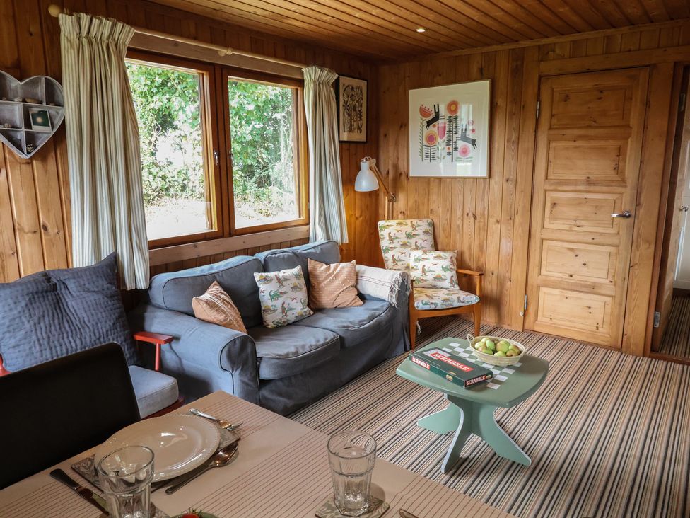 A living room with a sofa and armchairs at 10 Pinewood Retreat in Pinewood